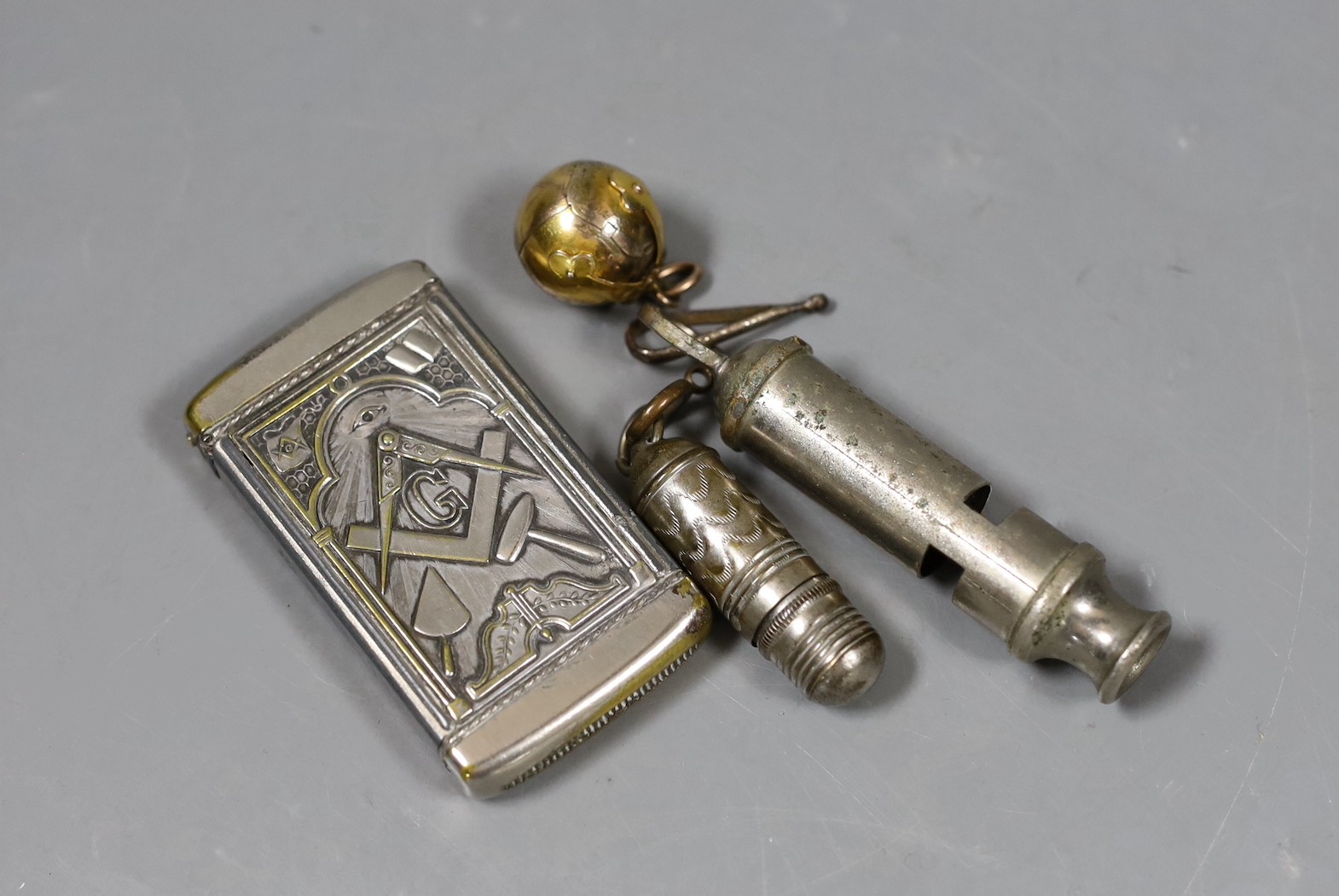 A Masonic gilt metal folding crucifix, Masonic vesta case, Police whistle, and dice case